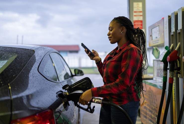 Donna al distributore di benzina